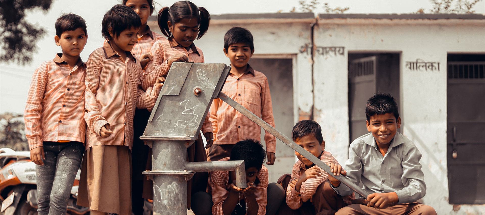 kids using a water pump